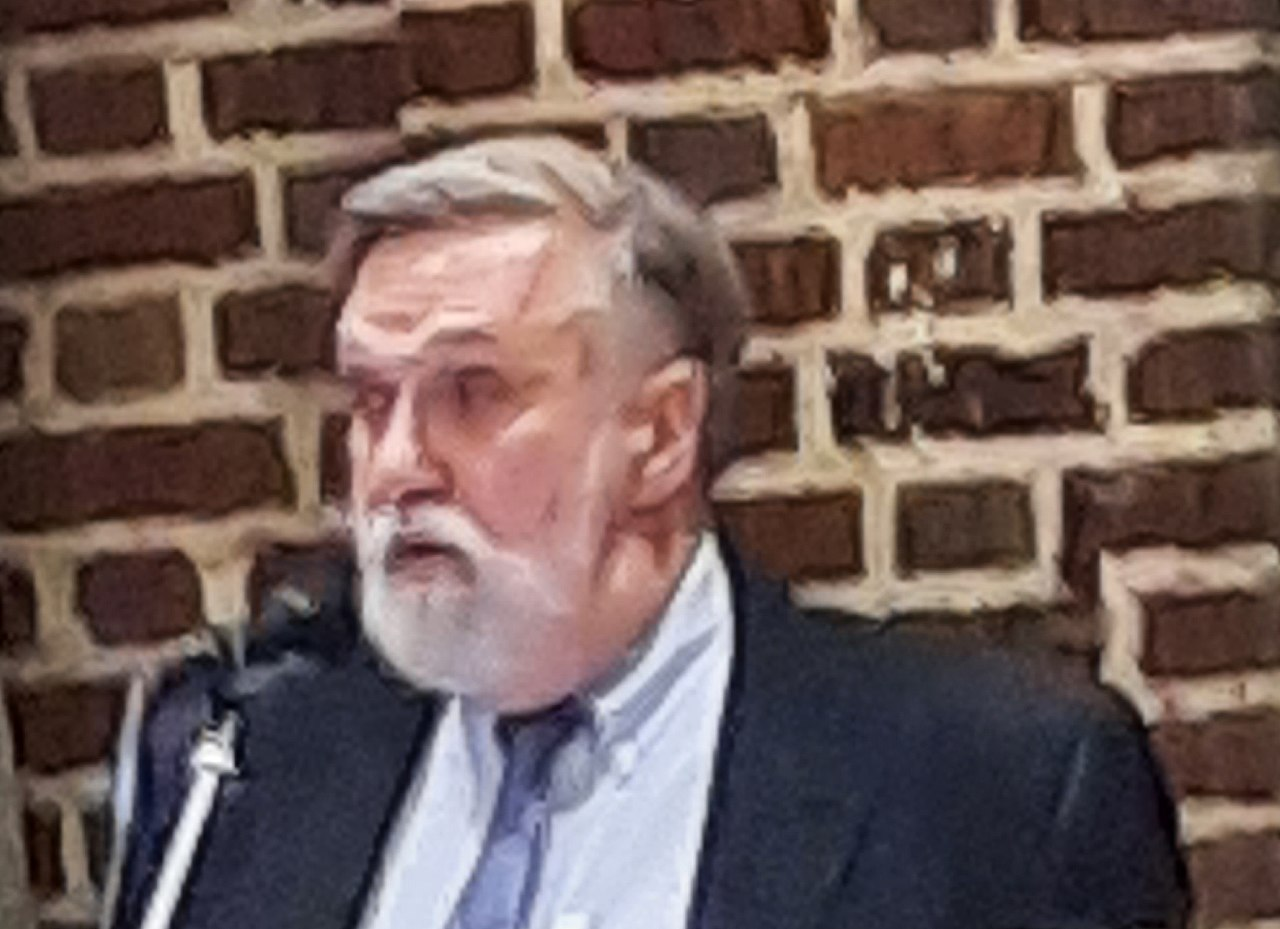 Picture of Dough Wilson at microphone. 